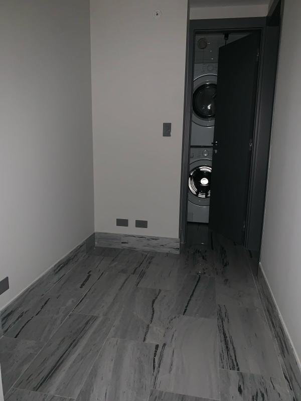 Contemporary kitchen with granite counter, stainless refrigerator, washer dryer in PH Nuovo Bella Vista