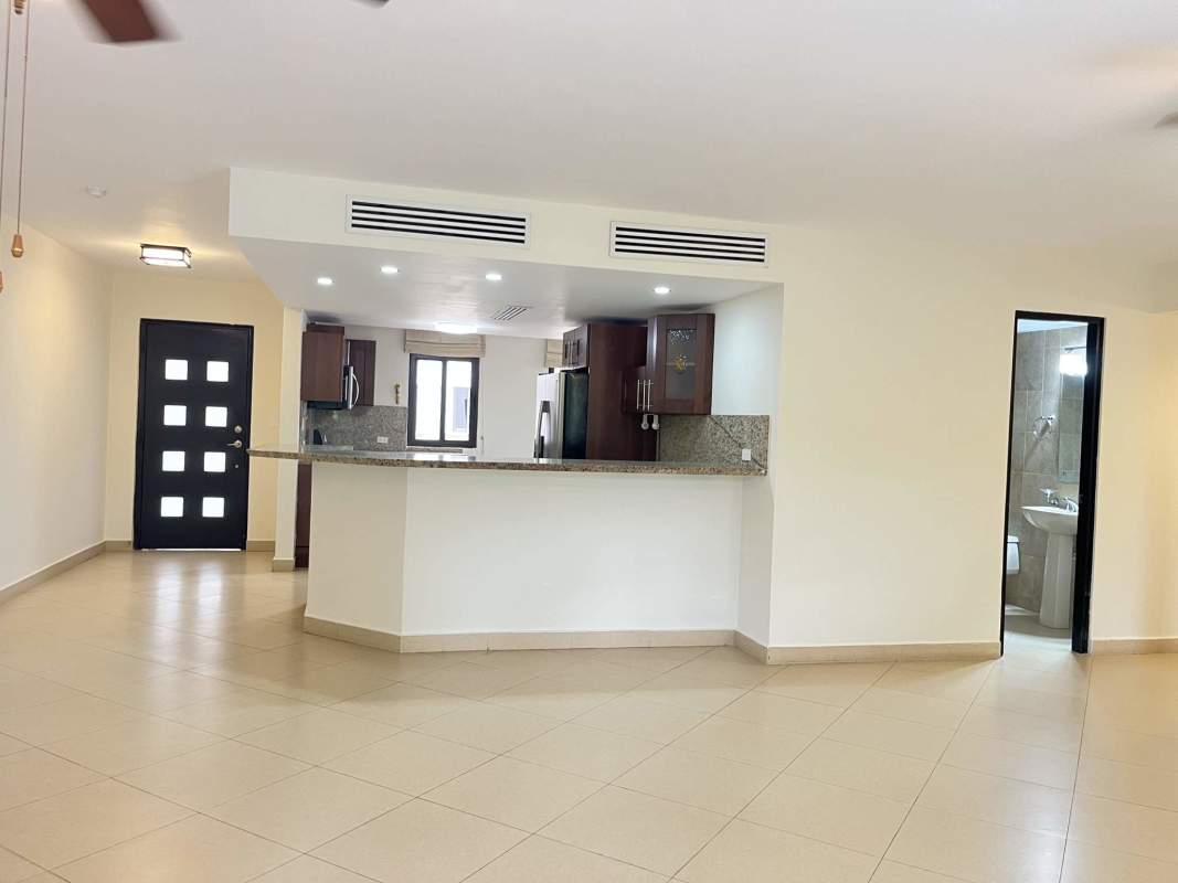 Bedroom featuring walk-in closet and access to balcony with garden view in Embassy Club Clayton