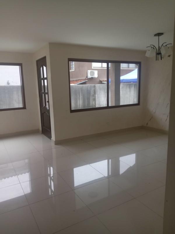 Interior staircase with tile steps and black iron railing in duplex house at San Miguelito Panama
