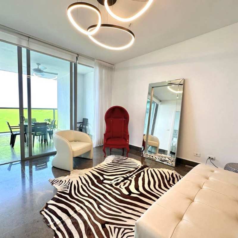 Spacious living area at PH Yoo with glass walls, ocean view terrace, modern decor