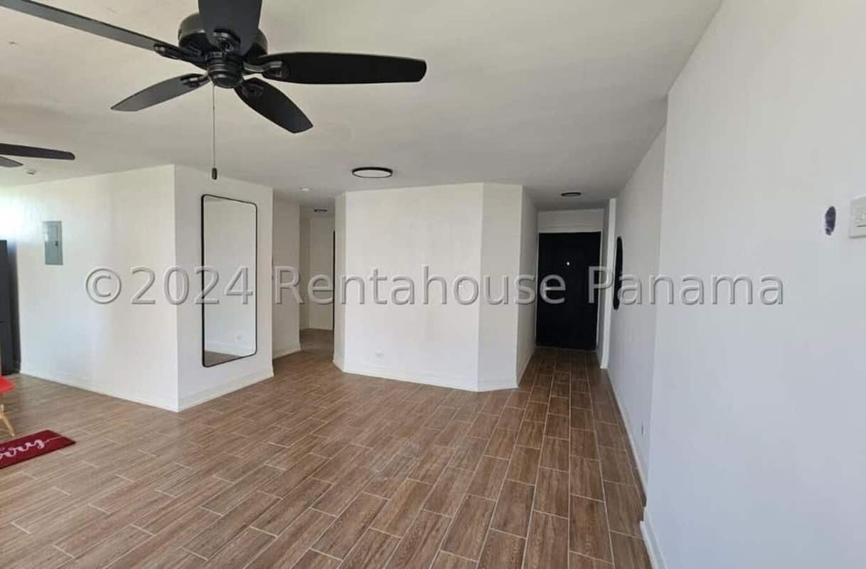 Bright living area with wall mirror, tile floor and ceiling fan Costa del Este Gardens apartment Panama City