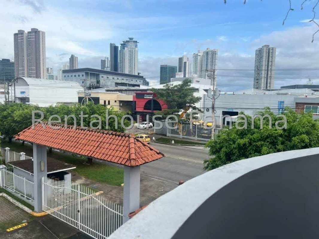 Entrance gate with city views and tiled roof at PH Costa del Este Gardens