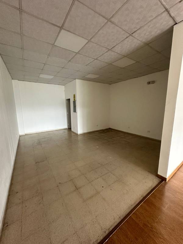 Spacious empty interior commercial unit tiled floor drop ceiling glass front in Panama City