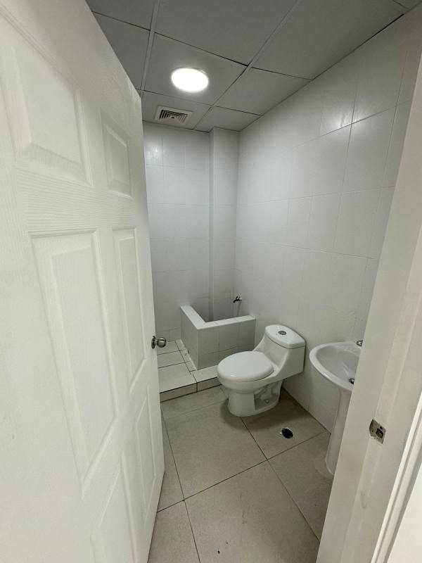 Minimalist commercial bathroom with toilet and sink in City Plaza Aeropuerto Panama