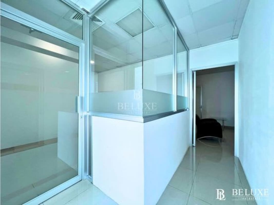 Office interior with glass dividers, tiled floors, modern ceiling lighting in PH Torre Global Bank Panama