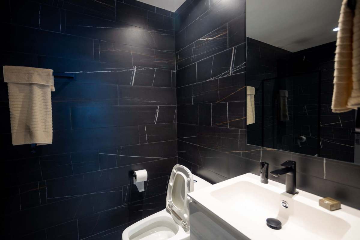 Indoor amenity lounge with LED steps, floor-to-ceiling glass, skyline views at Nuovo by Armani