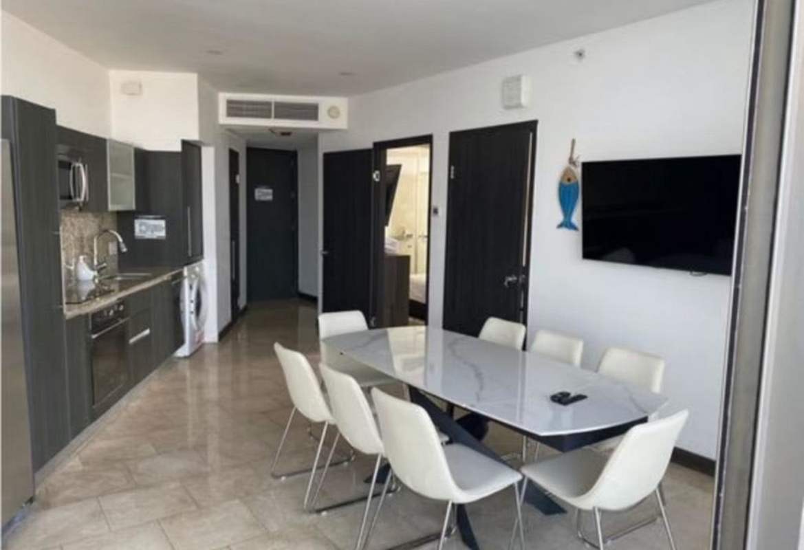 Open kitchen with marble dining area furnished apartment JW Marriott Punta Pacifica Panama