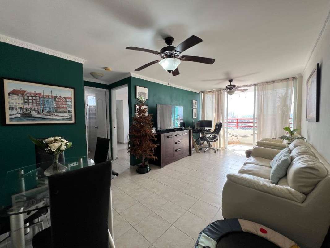 Living dining with green accent wall, balcony access in PH El Marquez Panama