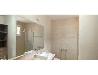 Contemporary kitchen featuring wood cabinetry and ample counter space in Bosques del Pacifico