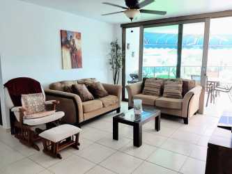 Open living dining area with large glass doors to balcony at Playa Blanca Resort beachfront apartment Panama