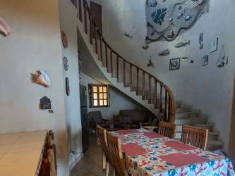 Coastal style dining area with wooden staircase inside beachfront Palenque Panama villa