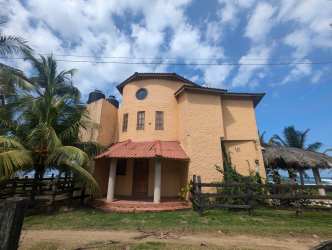 Mediterranean style beachfront house with tower and palm trees Palenque Panama