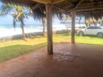 Covered patio overlooking palms and oceanfront in Palenque Panama Caribbean Villa