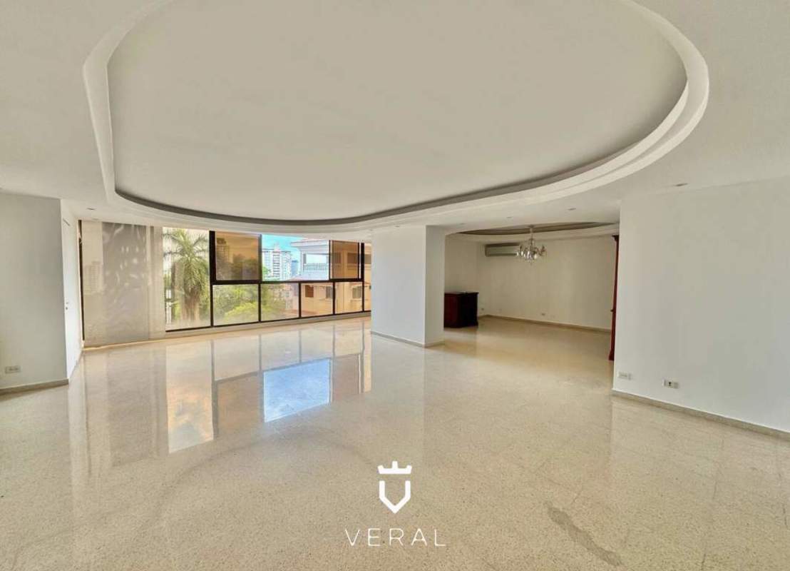 Kitchen with wood cabinetry, granite counters, island and appliances Torre La Cresta Panama