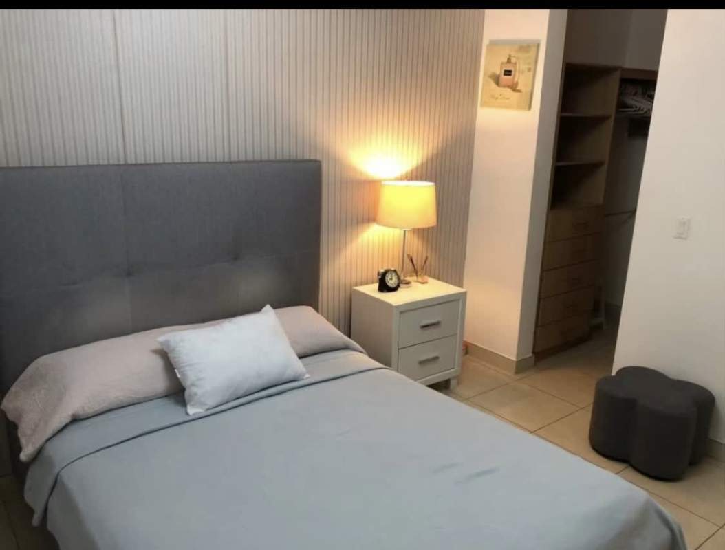 Bedroom with built-in closet and large window city skyline view Punta Pacífica Panama