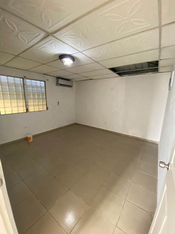 Large backyard with grass beside single-family house in Panama