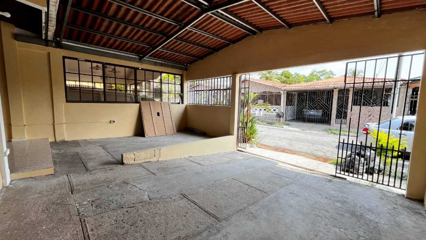Covered parking area with security gate and exposed beams in Puerta del Este neighborhood Tocumen