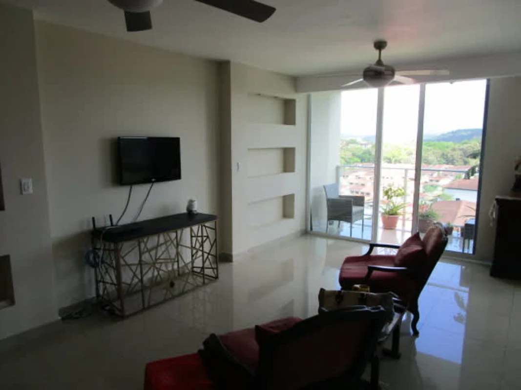 Bright living room with ceiling fan, sliding glass doors to balcony in PH Pine Hill Albrook Panama
