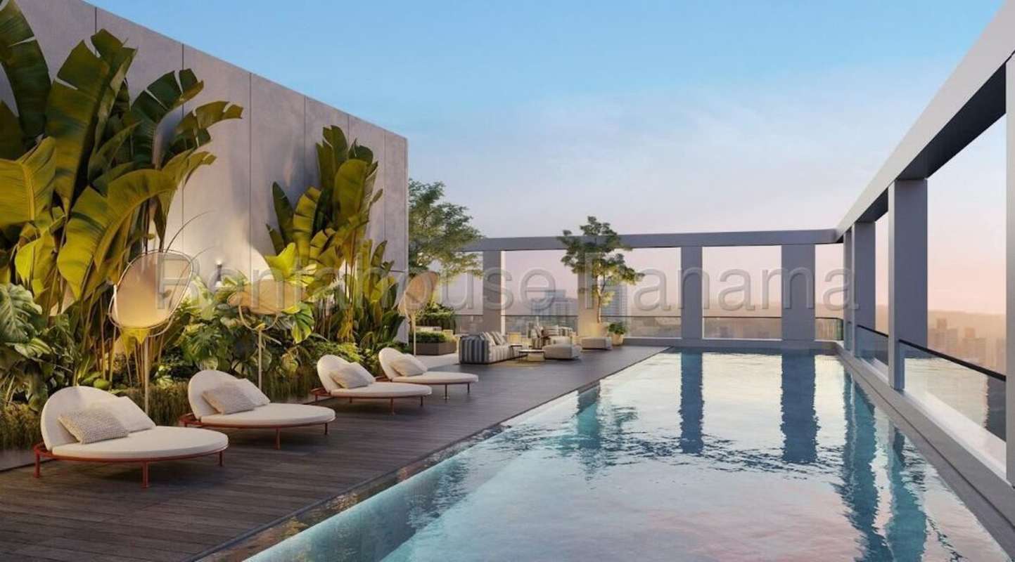 Panama skyline by twilight rooftop terrace MOVA Tower pool and lounge seating