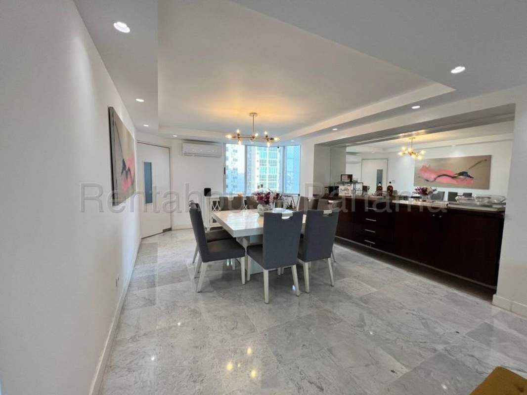Large modern living room with marble floors, city skyline views at Punta Paitilla luxury apartment Panama