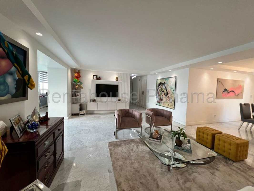 Spacious living room with marble flooring, accent wall and large windows in luxury apartment PH Residencia del Mar