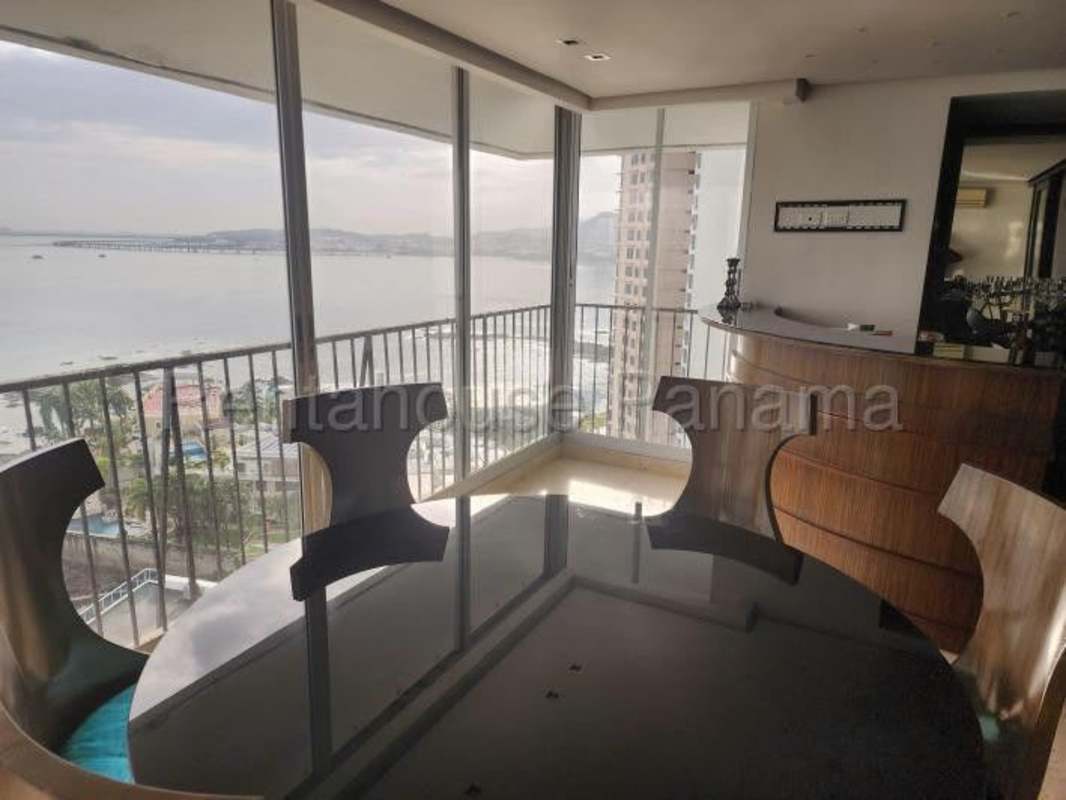 Dining area with panoramic ocean views and marble floors in remodeled apartment at PH Paitilla Tower Panama City
