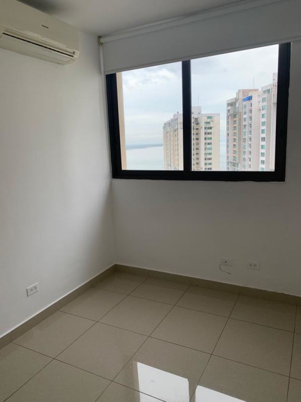 Bedroom with built-in closet and tile flooring in PH San Francisco Bay Panama City