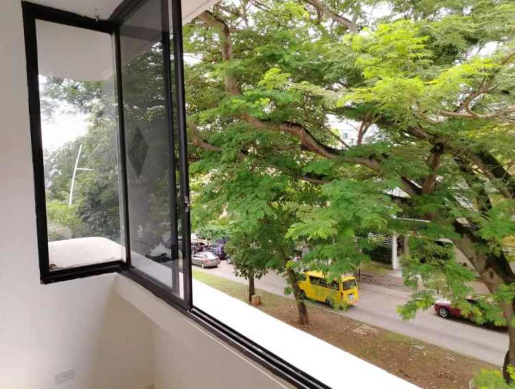 Balcony window with open city and green tree view PH Plaza 77 Vía Argentina Panama City