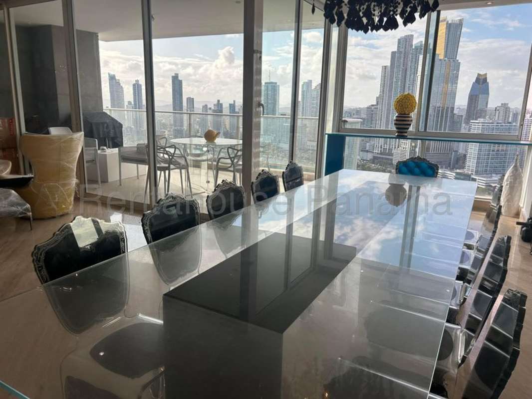 Spacious living room with large windows ocean and skyline views PH Ocean Park Panama City