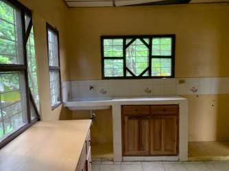 Rustic kitchen with tile backsplash and wood cabinetry for rent in David Chiriquí Panama