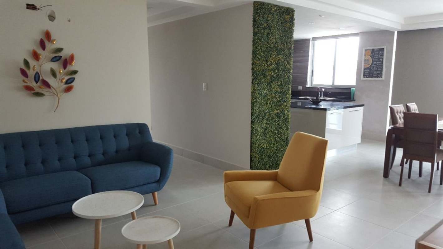 Modern open-plan living room with kitchen island and bright decor in PH Park City