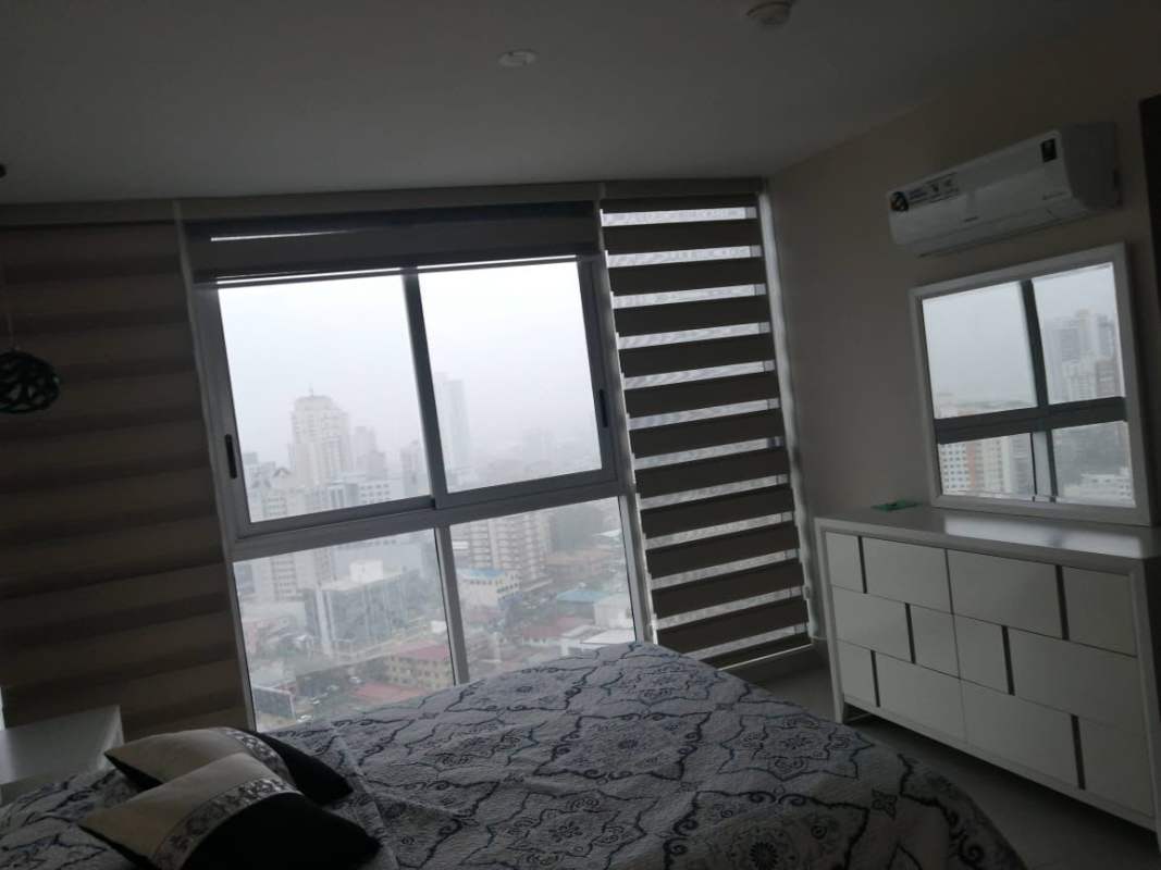 Bedroom with large windows, city view, air conditioning in PH Park City Obarrio