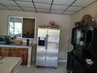Traditional kitchen with refrigerator space, wooden cabinets, tile floor, Volcán Chiriquí