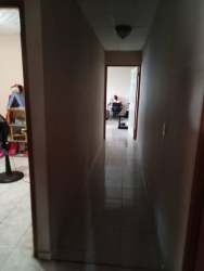 Long tiled hallway with access to multiple rooms inside house for sale in Volcán Panama