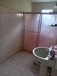 Bathroom featuring tiled walls, walk-in shower with frosted glass, sink in Volcán Panama house