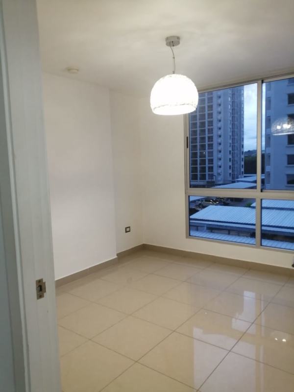 Empty bedroom with large window and mountain view at PH Condado Gardens Condado del Rey Panama