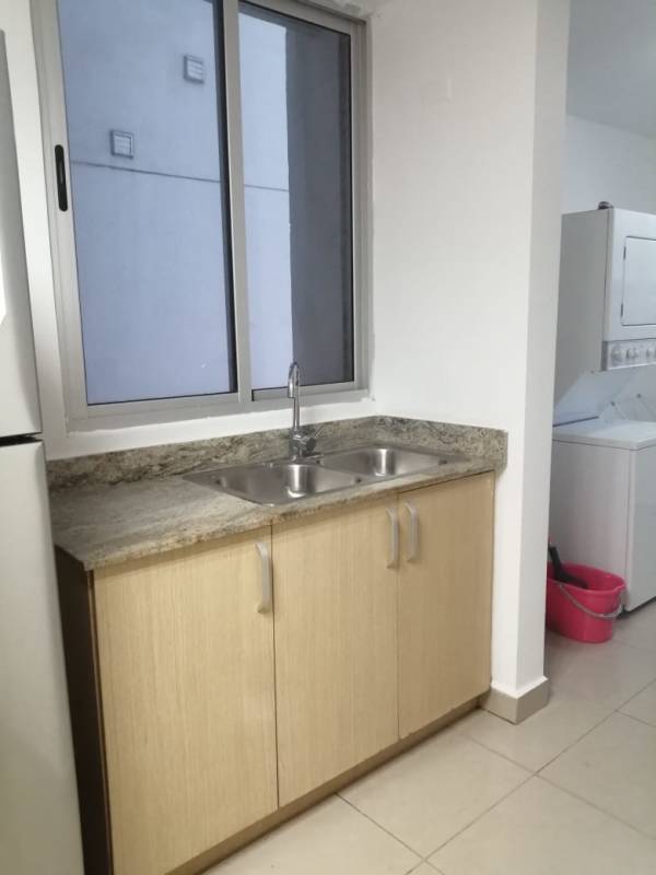 Kitchen with granite countertops, double sink and large window at PH Condado Gardens Condado del Rey Panama