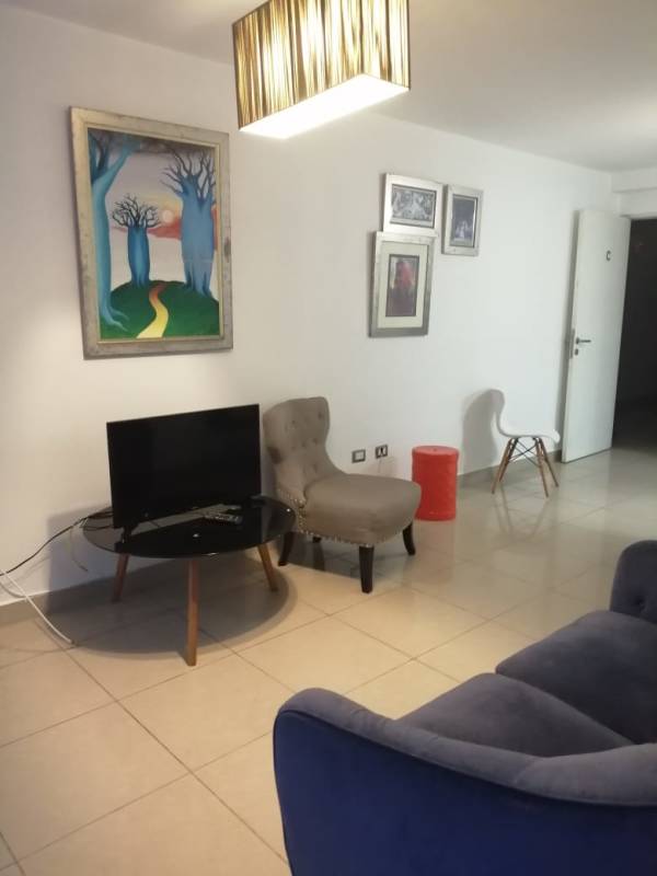 Bright bedroom with ceramic tile floors and city views at PH Condado Gardens Condado del Rey Panama