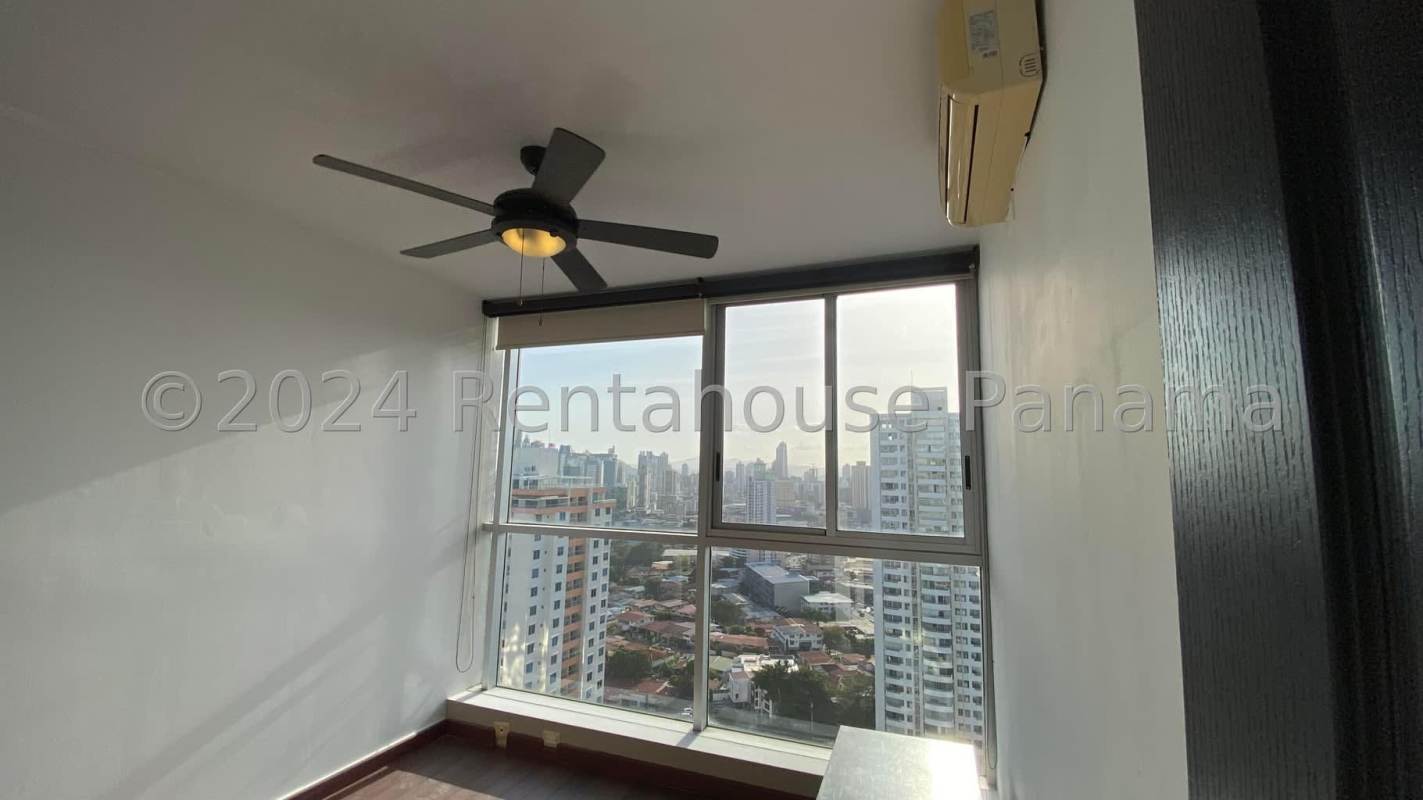 Bedroom with large window overlooking the city skyline, ceiling fan, AC PH Vitro Tower Panama City
