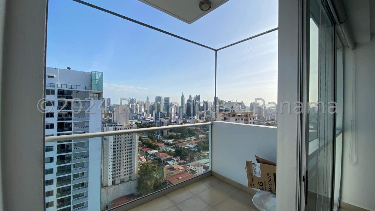 Corner balcony with glass railing, skyline view of Panama City at PH Vitro Tower