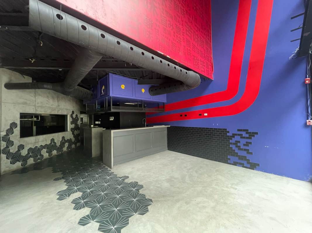 Colorful industrial commercial interior in Marbella, Panama City with murals, ductwork, concrete walls, geometric tiles, restaurant potential