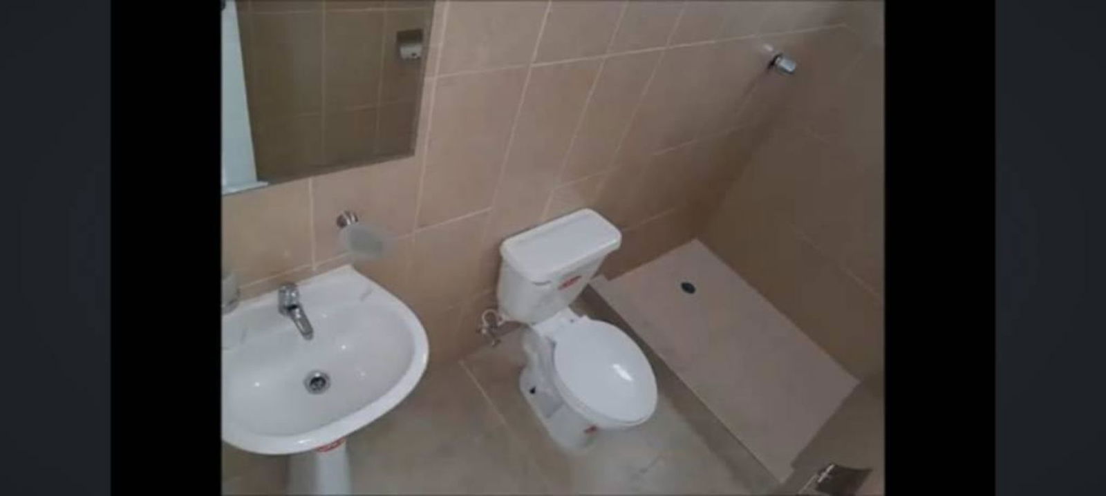 Minimalist bathroom with beige tile and walk-in shower at PH Mystic Towers Panama