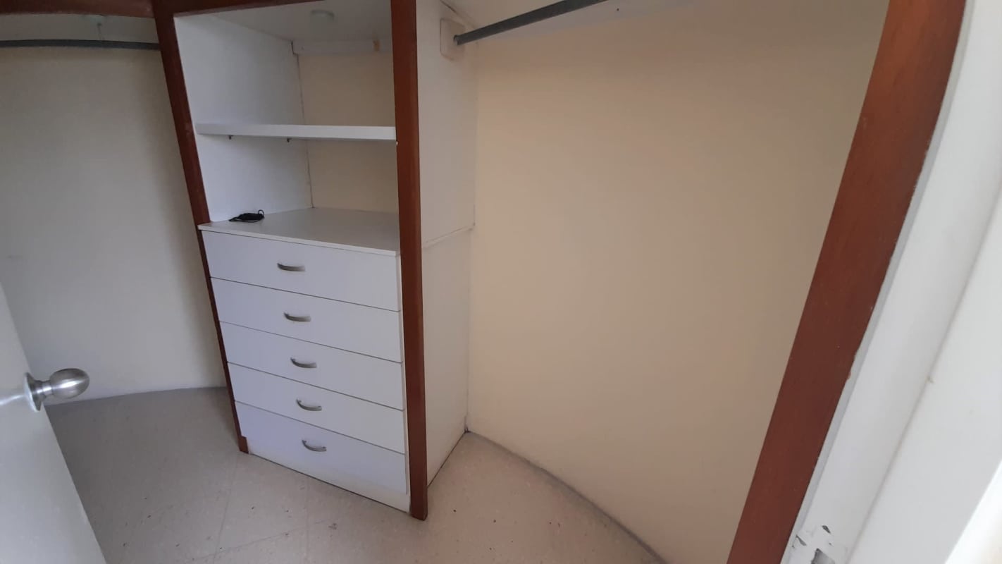 Walk-in closet with shelving, hanging rods, drawer unit PH Marfil Obarrio Panama