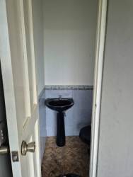 Bathroom with glass shower wood vanity in Volcán Panama house