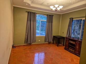 Bedroom with big window ceramic tile floor in mountain home Volcán Panama