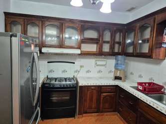 Large living room with ceramic tile floors and bright windows in Volcán Panama house