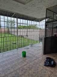 Spacious kitchen with wooden cabinets tiled backsplash stove in Volcán house Panama