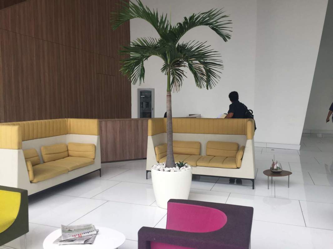 Empty office space with floor-to-ceiling windows and panoramic city and ocean view in PH BICSA Tower