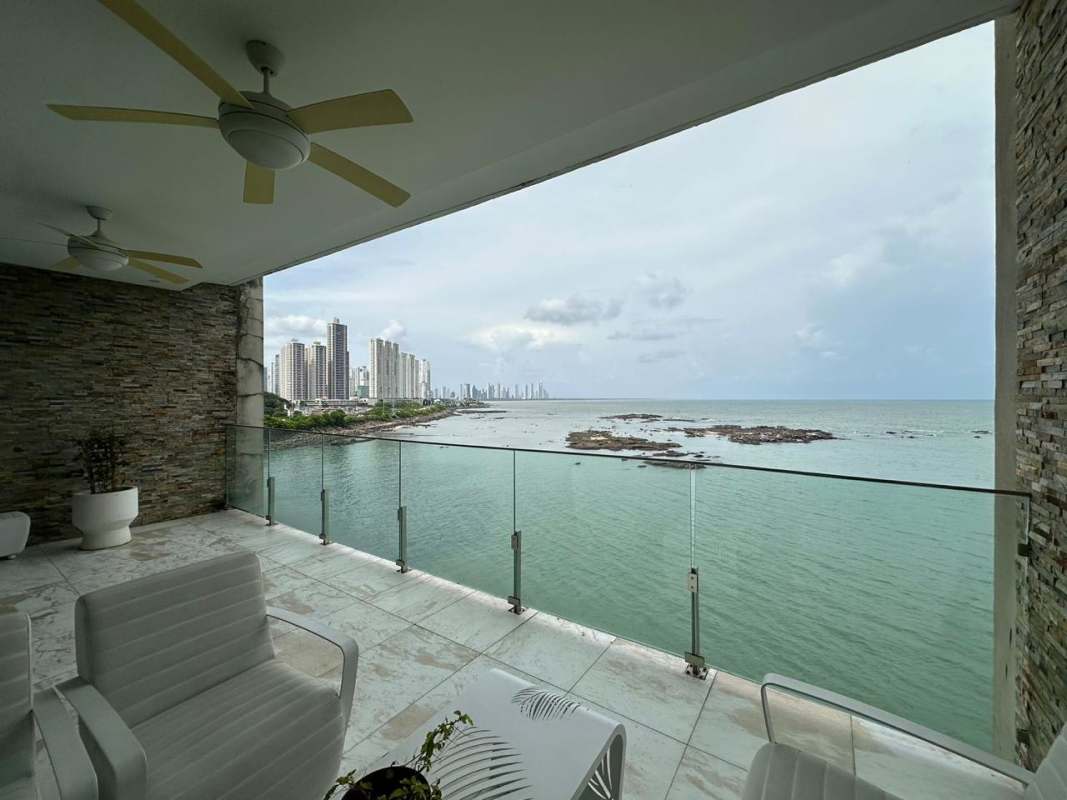 Private terrace with ocean panorama, white outdoor furniture in PH The Residence Punta Pacífica Panama