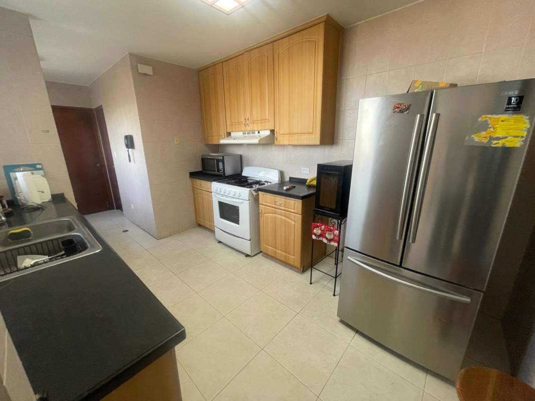 Bright living dining area with large windows, furnished with sofas and dining set in PH Lexus Tower Panama